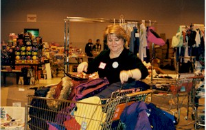 Woman sorting through coats 